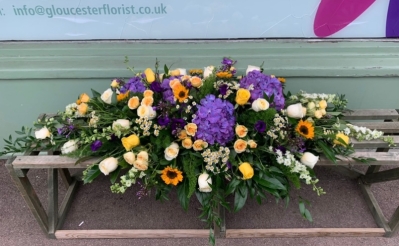 Yellow and purple cottage garden coffin spray