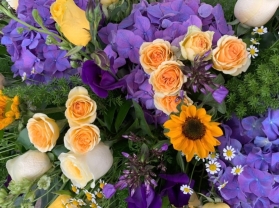 Yellow and purple cottage garden coffin spray